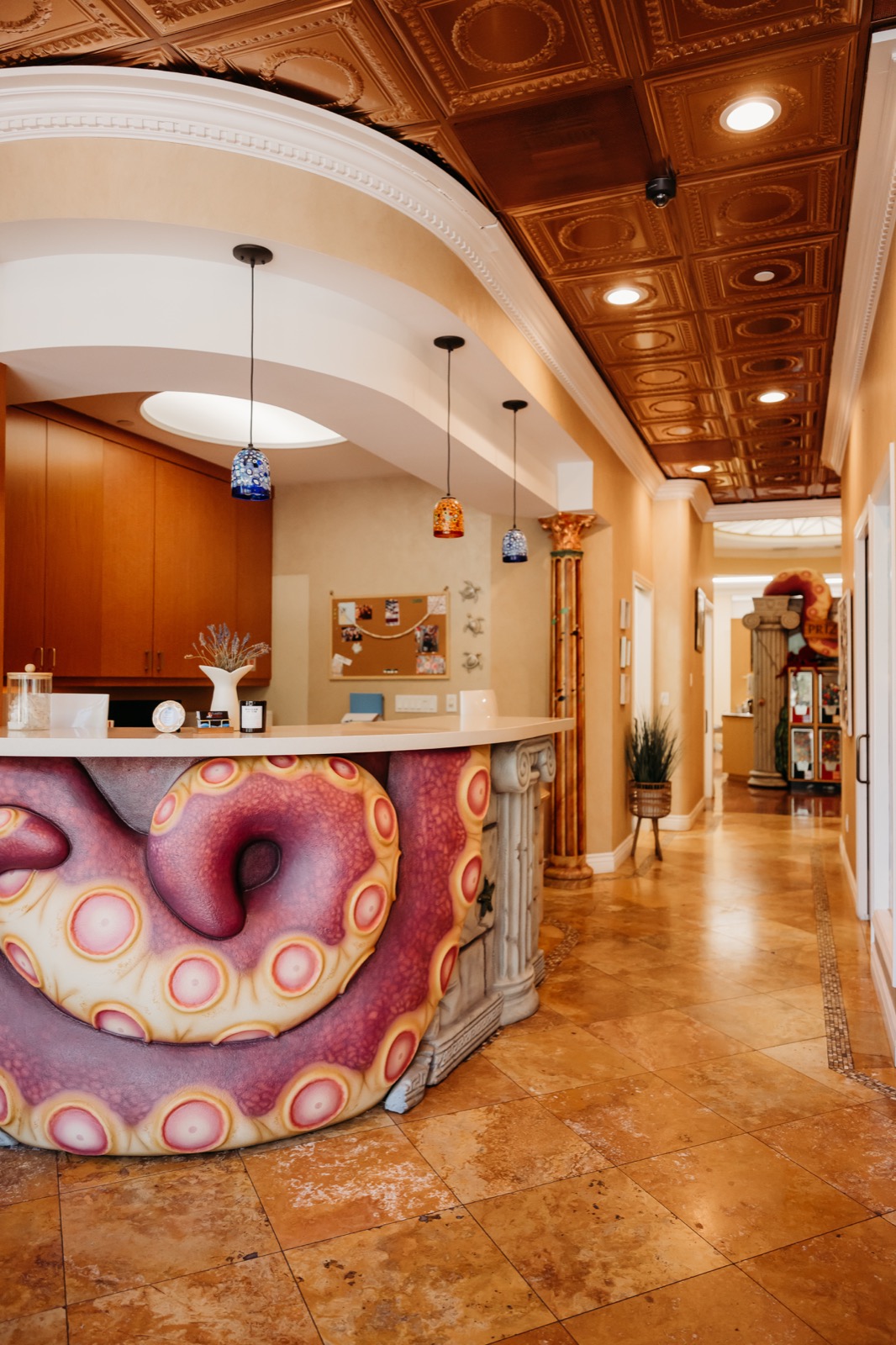 Atlantis reception desk wrapped with a colorful octopus beside the office hallway